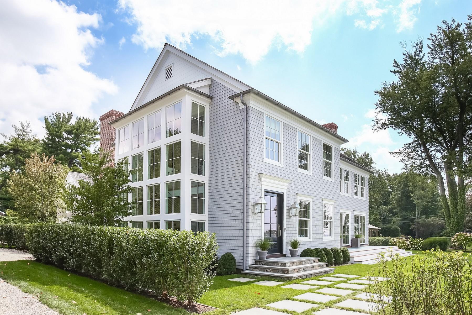106 Pear Tree Point Road Darien, CT 06820 - Photo 2 of 43 a front view of a building with a garden and plants