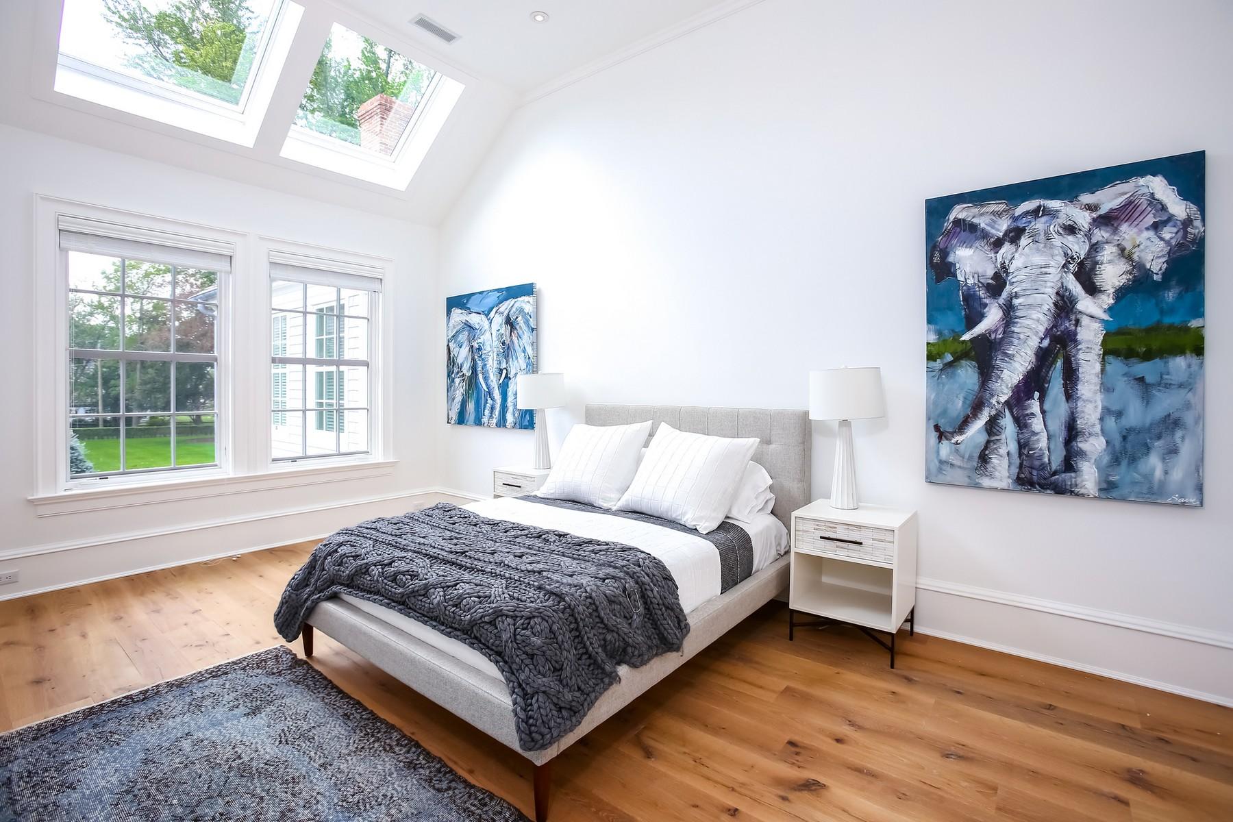 106 Pear Tree Point Road Darien, CT 06820 - Photo 22 of 43 a bedroom with a bed lamp and window