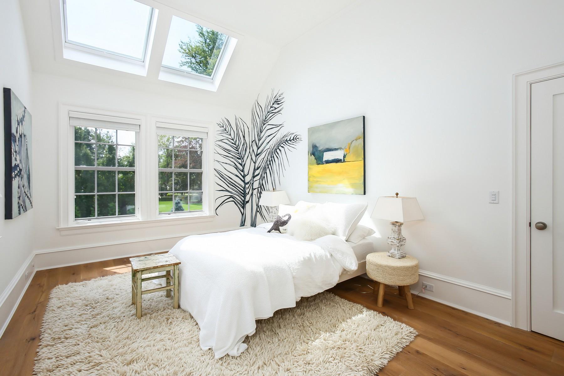 106 Pear Tree Point Road Darien, CT 06820 - Photo 23 of 43 a bedroom with a bed and wooden floor