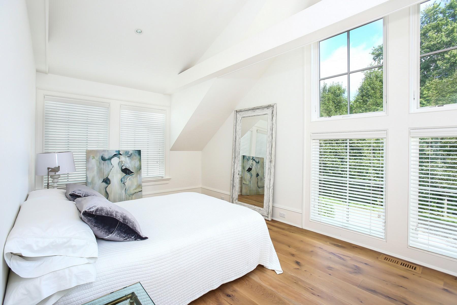 106 Pear Tree Point Road Darien, CT 06820 - Photo 25 of 43 a bedroom with a bed window and wooden floor