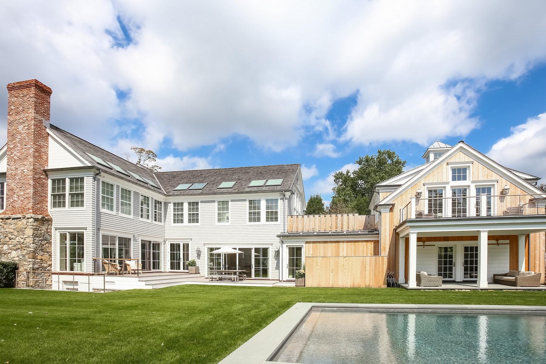 106 Pear Tree Point Road Darien, CT 06820 - Photo 33 of 43 a front view of a house with a garden