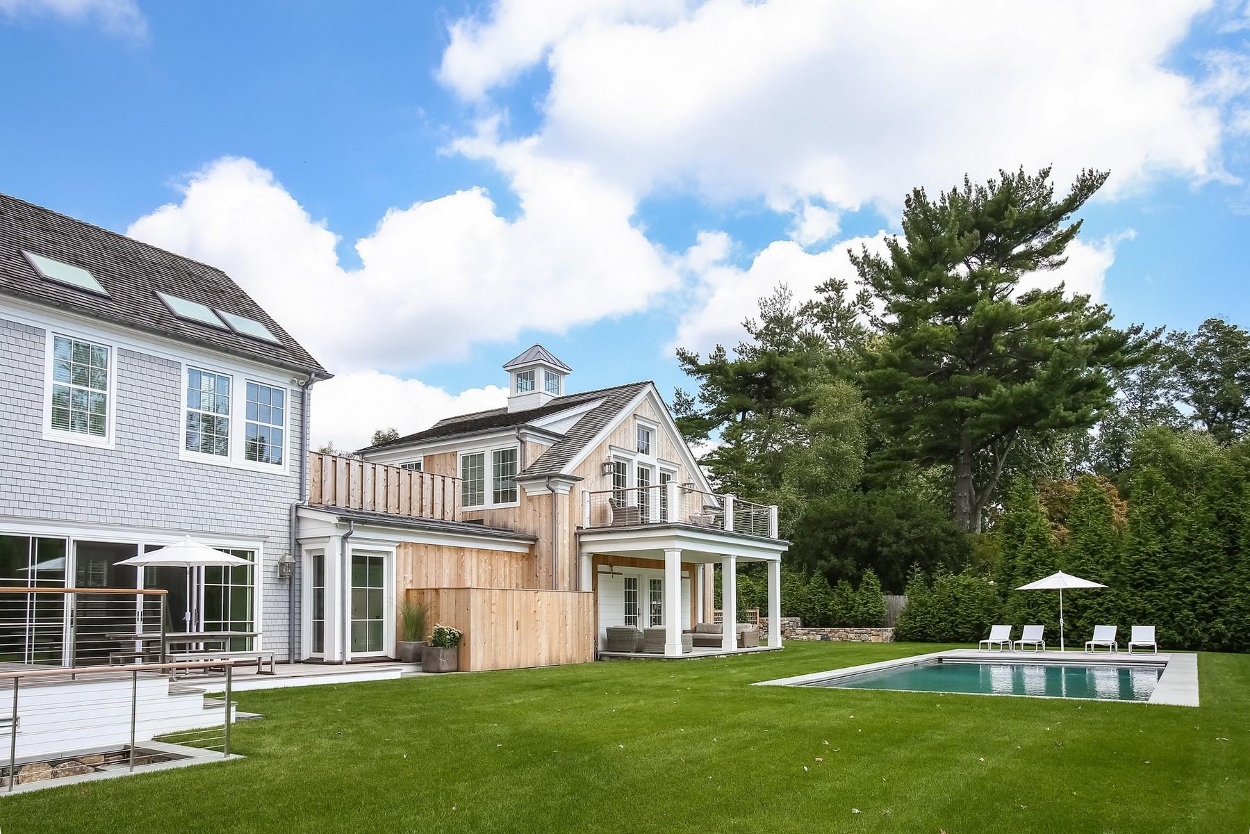 106 Pear Tree Point Road Darien, CT 06820 - Photo 35 of 43 a front view of a house with a garden