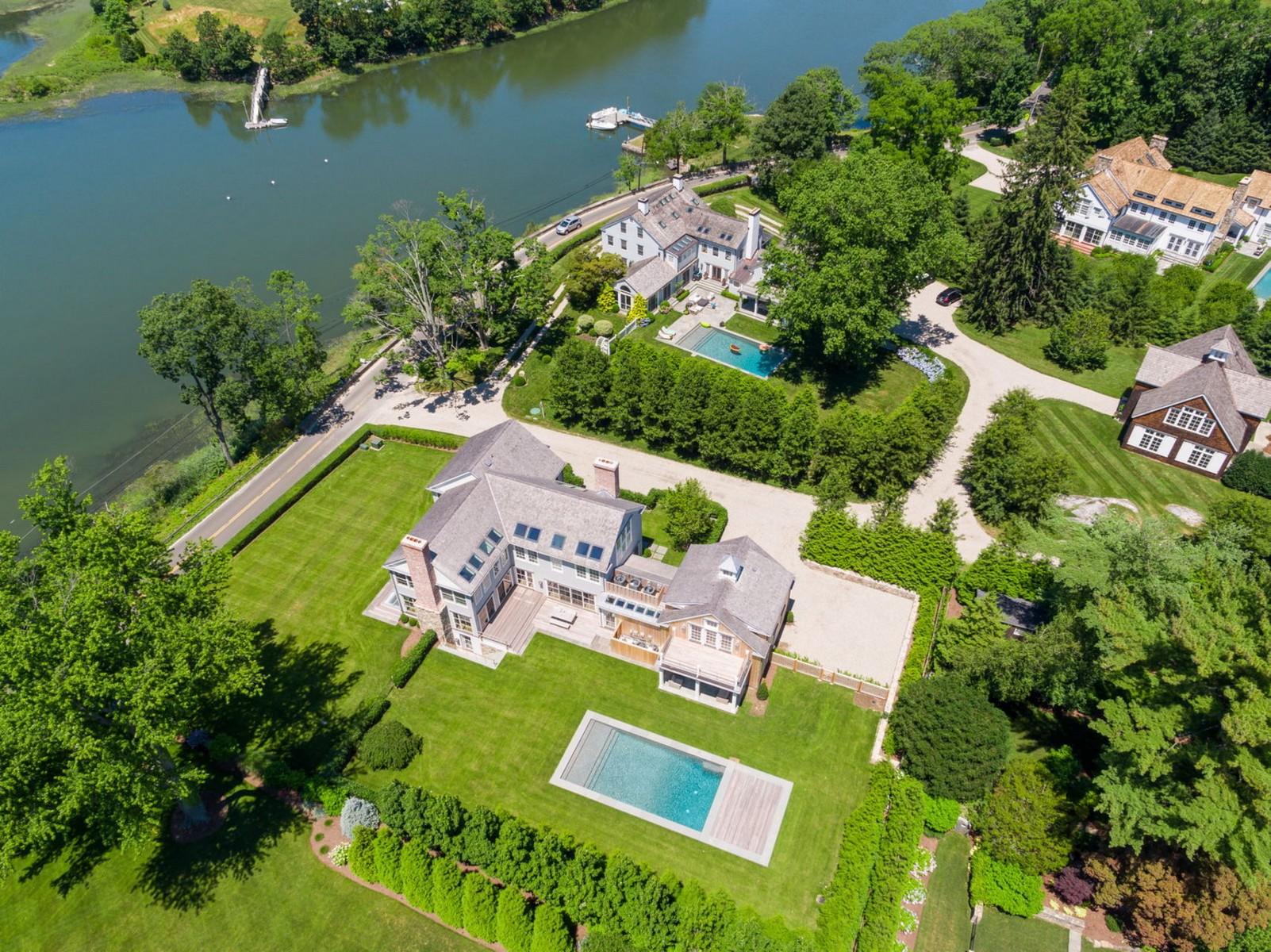 106 Pear Tree Point Road Darien, CT 06820 - Photo 38 of 43 an aerial view of a house with a garden and lake view