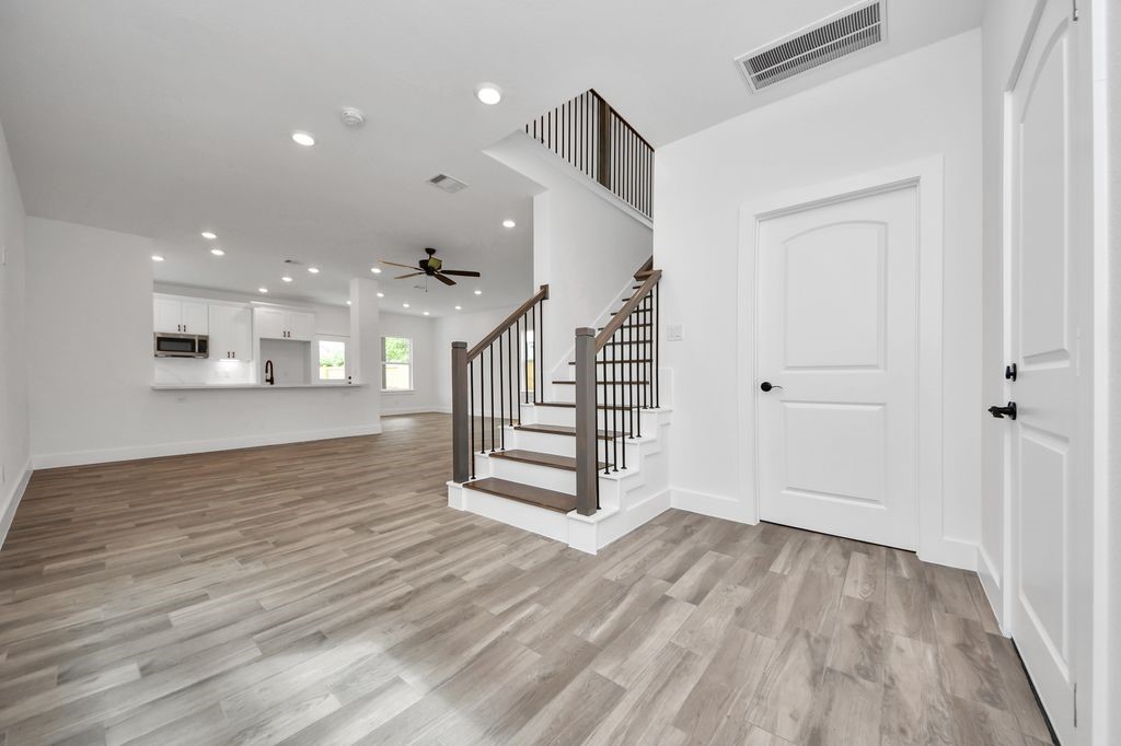 767 Marjorie Street Houston, TX 77088 - Photo 11 of 20 a view of a hallway with wooden floor and staircase