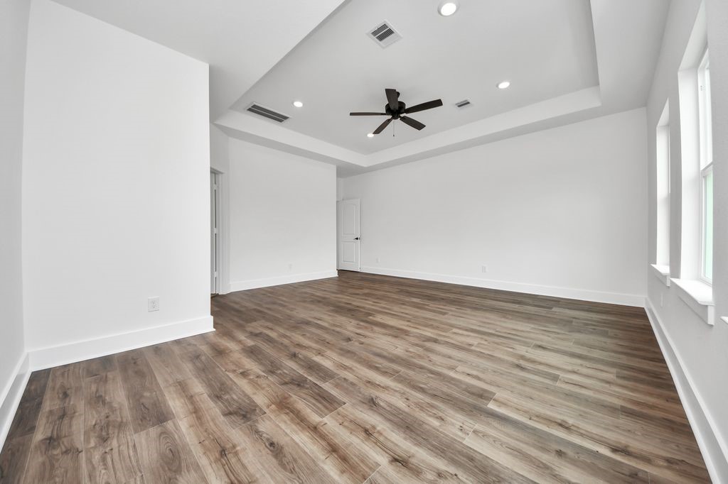 767 Marjorie Street Houston, TX 77088 - Photo 16 of 20 wooden floor in an empty room with a window