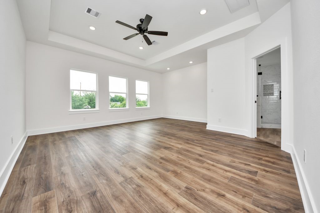 767 Marjorie Street Houston, TX 77088 - Photo 7 of 20 wooden floor in an empty room with a window