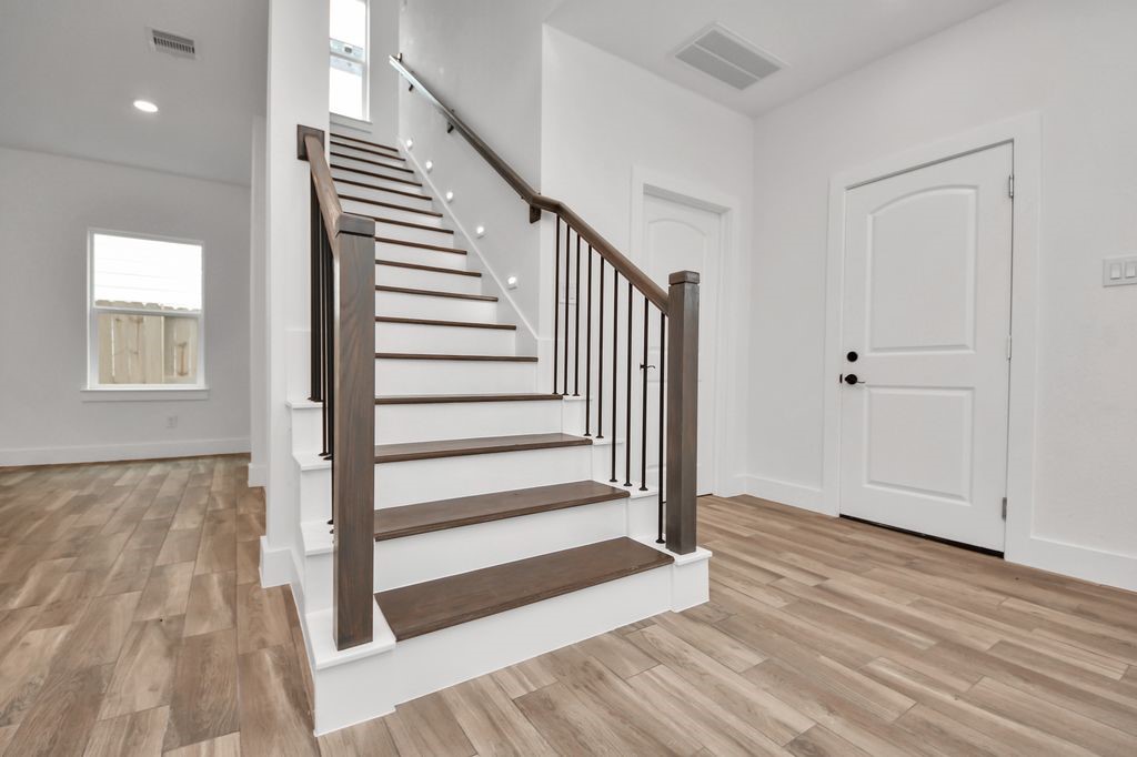 767 Marjorie Street Houston, TX 77088 - Photo 8 of 20 wooden floor in an empty room with a window and wooden floor