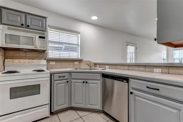a kitchen with a sink stove and cabinets