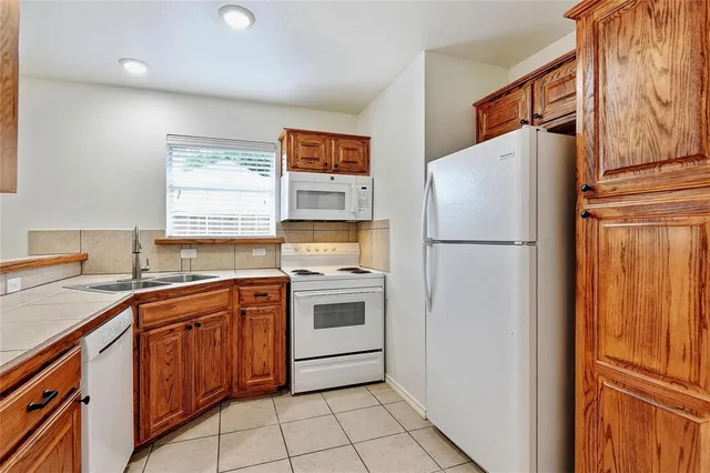 a kitchen with stainless steel appliances a refrigerator sink and cabinets
