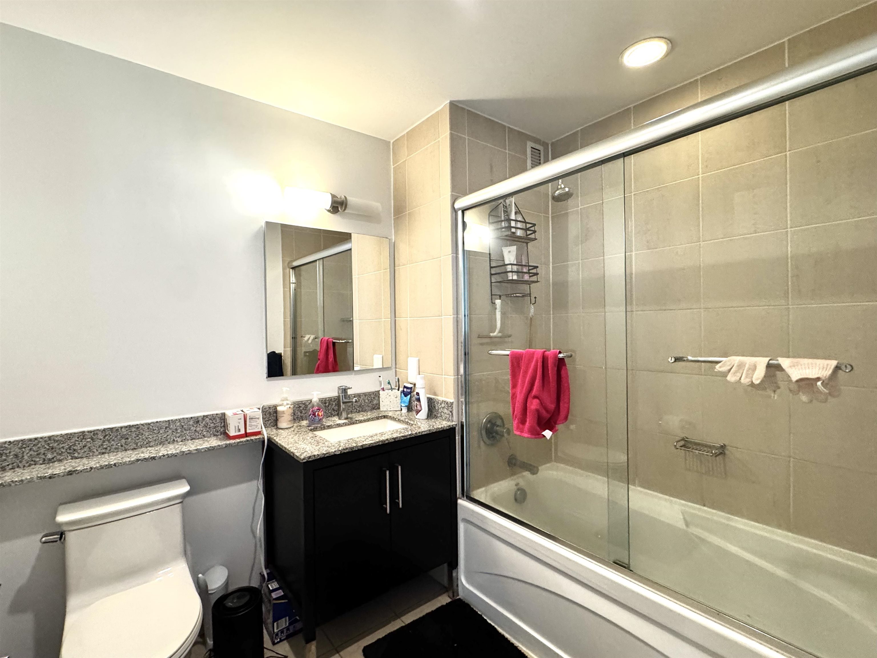 1 Shore Lane, Unit 1609 Jersey City, NJ 07310 - Photo 11 of 27 a bathroom with a sink vanity tub and shower