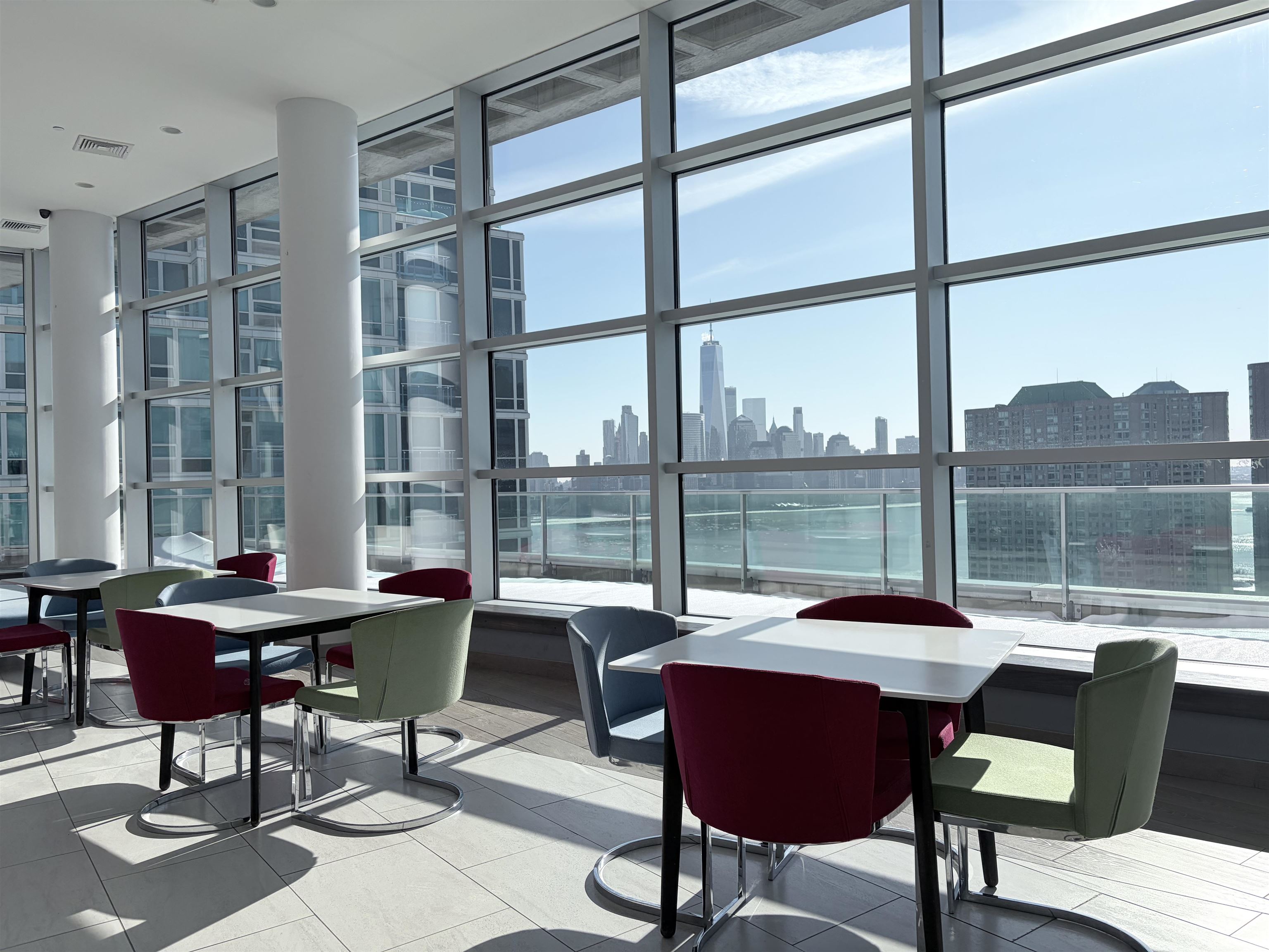 1 Shore Lane, Unit 1609 Jersey City, NJ 07310 - Photo 17 of 27 a living room with furniture and a window