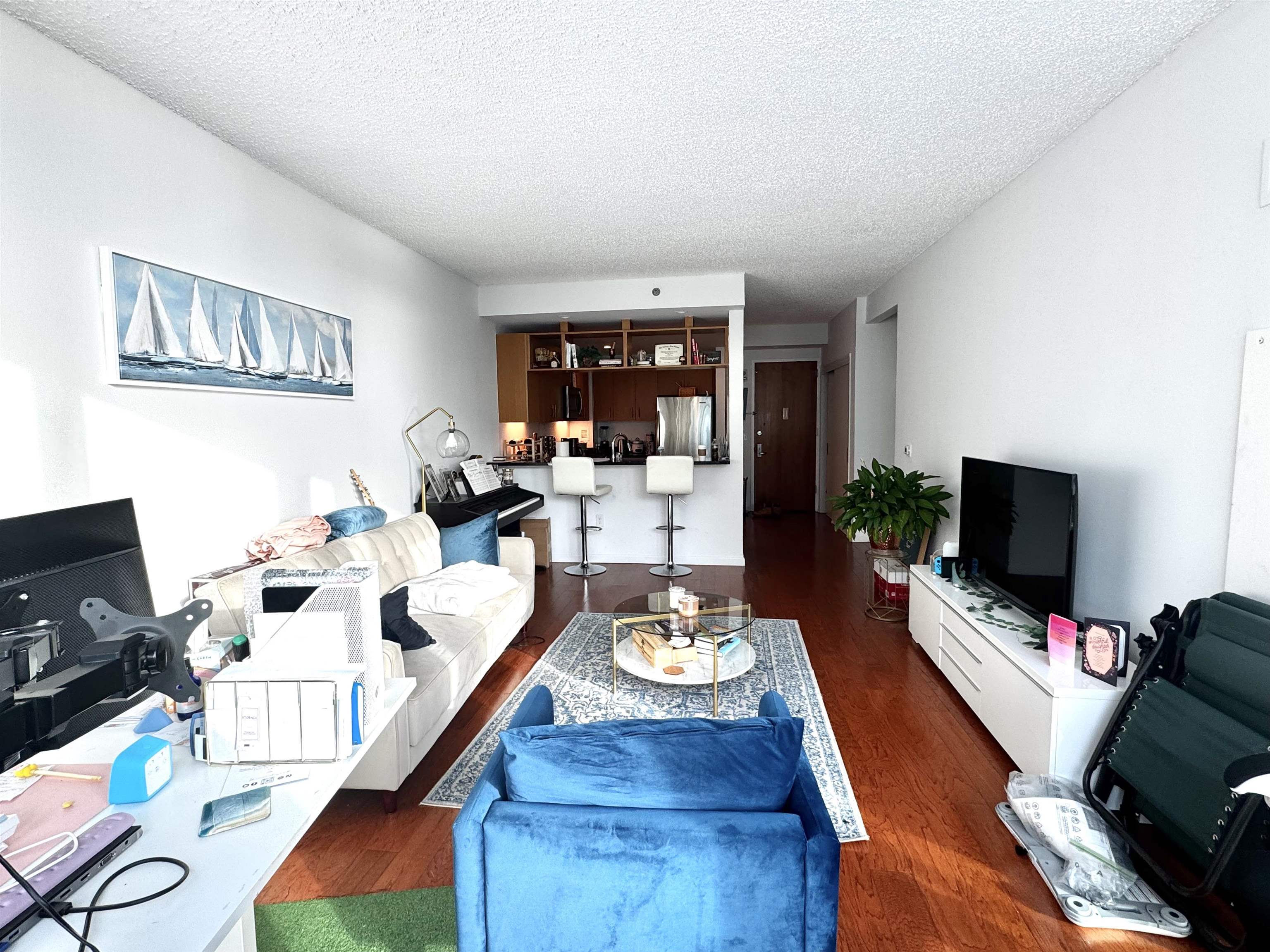 1 Shore Lane, Unit 1609 Jersey City, NJ 07310 - Photo 7 of 27 a living room with fireplace furniture and a flat screen tv