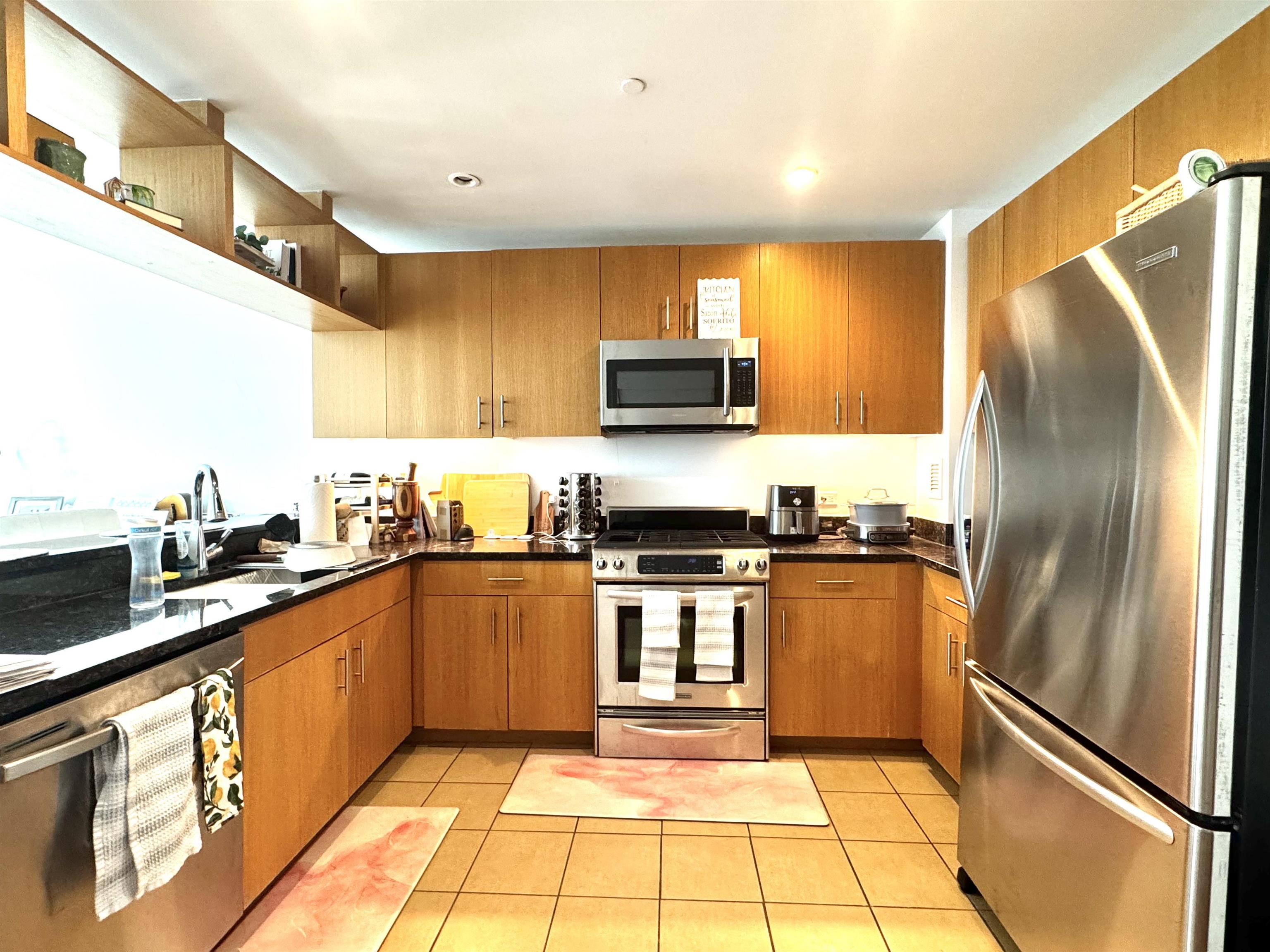 1 Shore Lane, Unit 1609 Jersey City, NJ 07310 - Photo 9 of 27 a kitchen with stainless steel appliances granite countertop a refrigerator a sink a stove a microwave and island