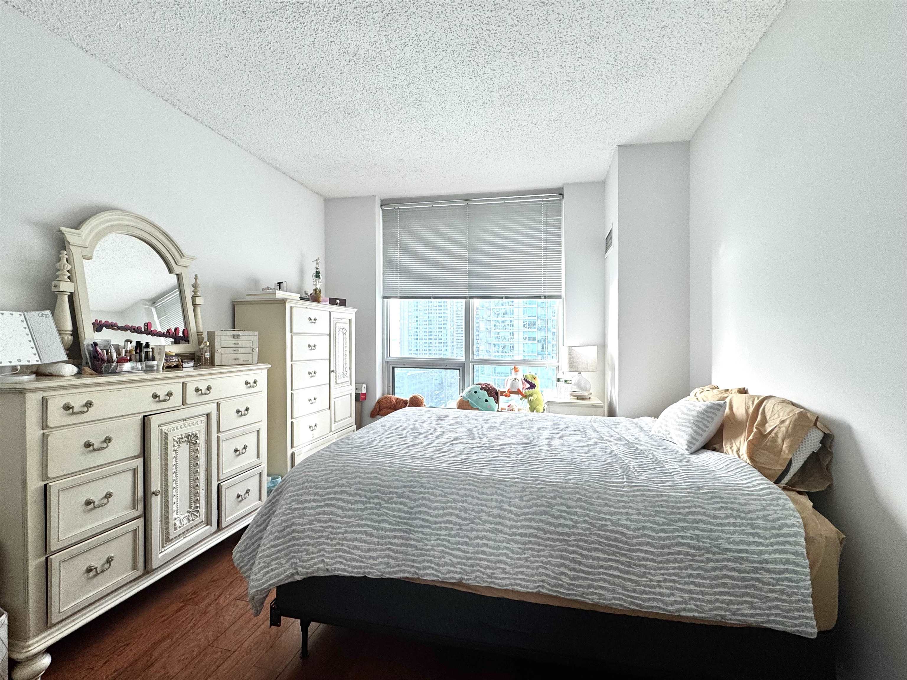 1 Shore Lane, Unit 1609 Jersey City, NJ 07310 - Photo 10 of 27 a bedroom with a bed a dresser next to a window