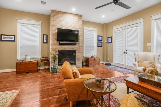 a living room with fireplace furniture and a flat screen tv