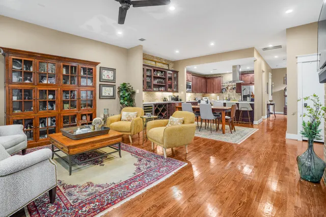 a living room with furniture and a book shelf