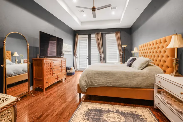 a bedroom with a bed and large windows