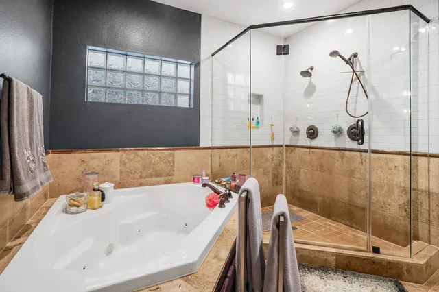 a bathroom with a tub a sink and a shower