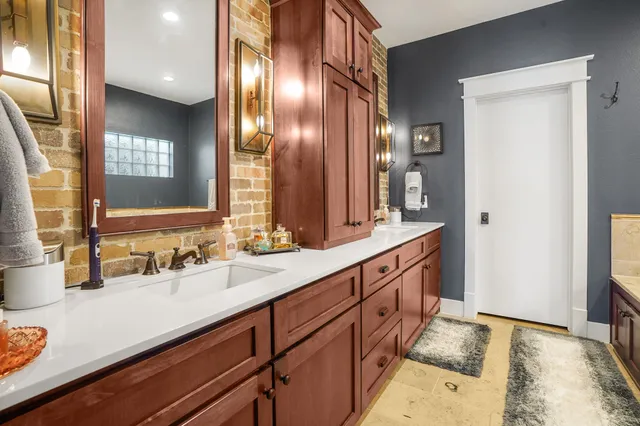 a spacious bathroom with double vanity and a mirror