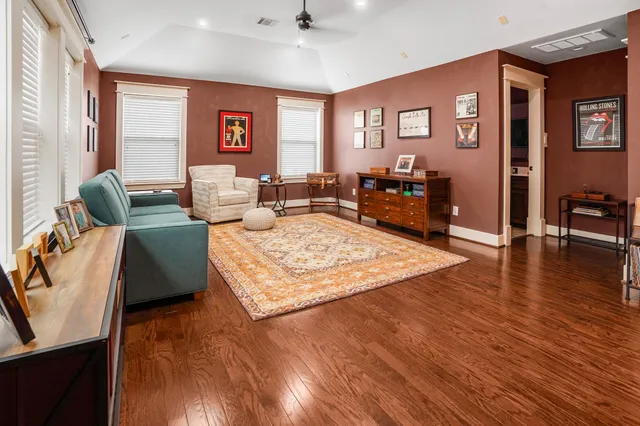 a living room with furniture rug and wooden floor