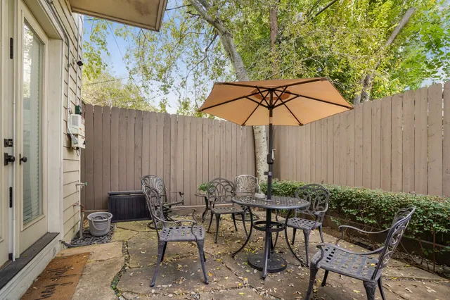 a view of a backyard with furniture and plants