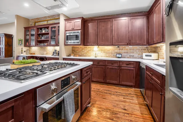 a kitchen with stainless steel appliances granite countertop a stove and a sink