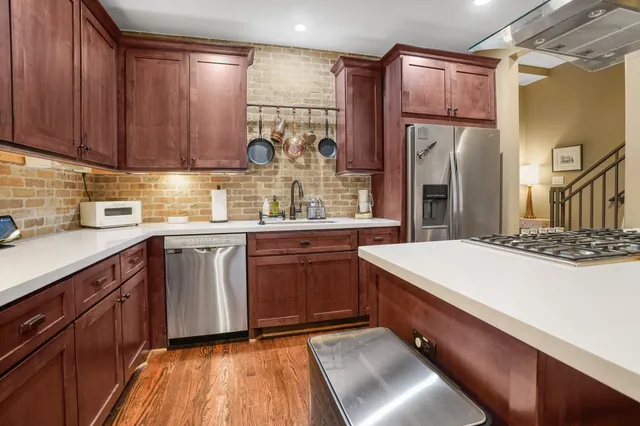 a kitchen with refrigerator and cabinets