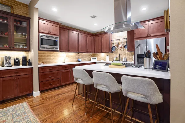 a kitchen with a table chairs sink and cabinets