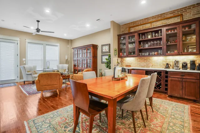 a dining room with stainless steel appliances kitchen island granite countertop a table and chairs