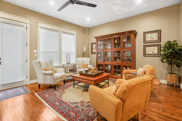 a living room with furniture and a book shelf