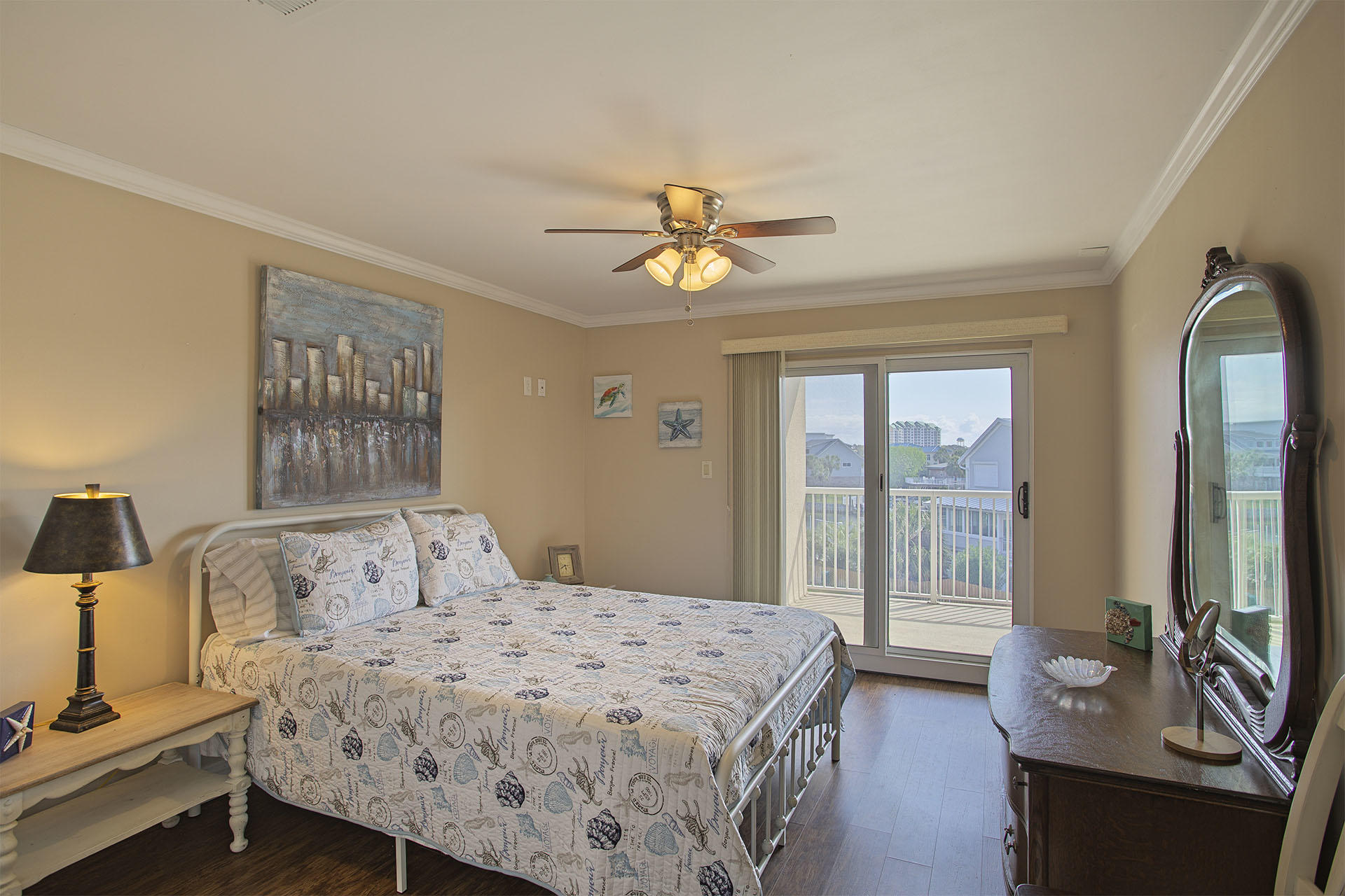 195 Durango Road, Unit 3D Destin, FL 32541 - Photo 6 of 22 a bedroom with a bed a chandelier and a flat tv screen on dresser