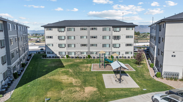 1700 South Sandhill Road West, Unit E 301 Orem, UT 84058 - Photo 17 of 20 Central green space featuring a playground with slides and a covered picnic area