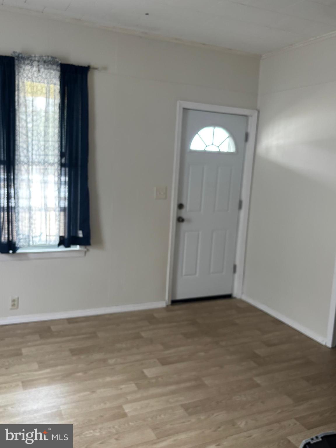 2 Blacks Terrace Paulsboro, NJ 08066 - Photo 2 of 24 a view of an empty room with wooden floor and a window