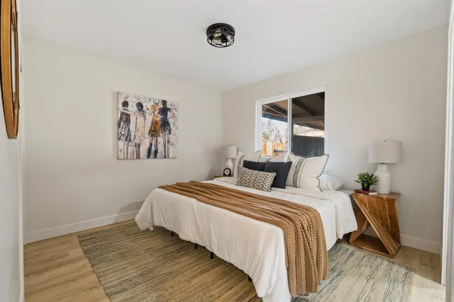 a bedroom with a bed and a window