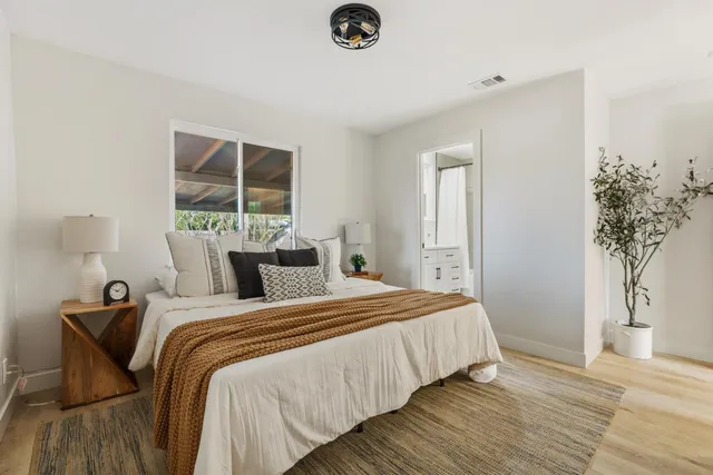 a bedroom with bed and a window