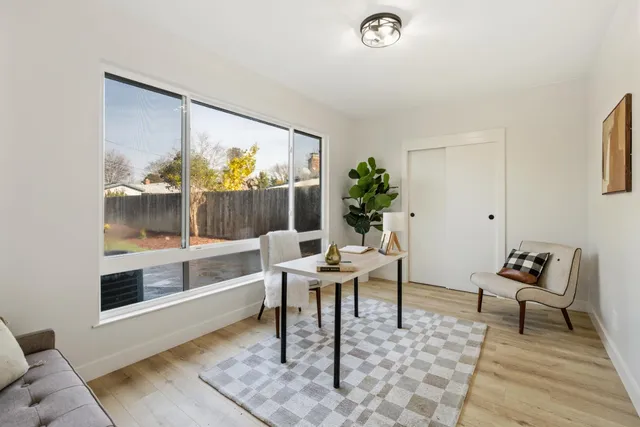 a work room with wooden floor and a rug