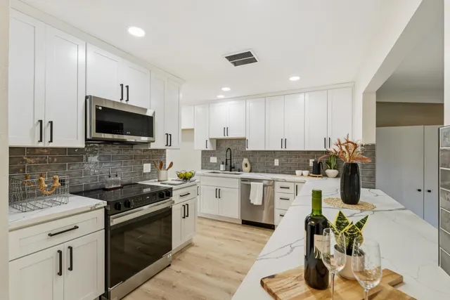 a kitchen with a sink stove and microwave