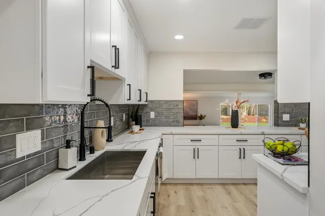 a kitchen with a sink cabinets and stainless steel appliances
