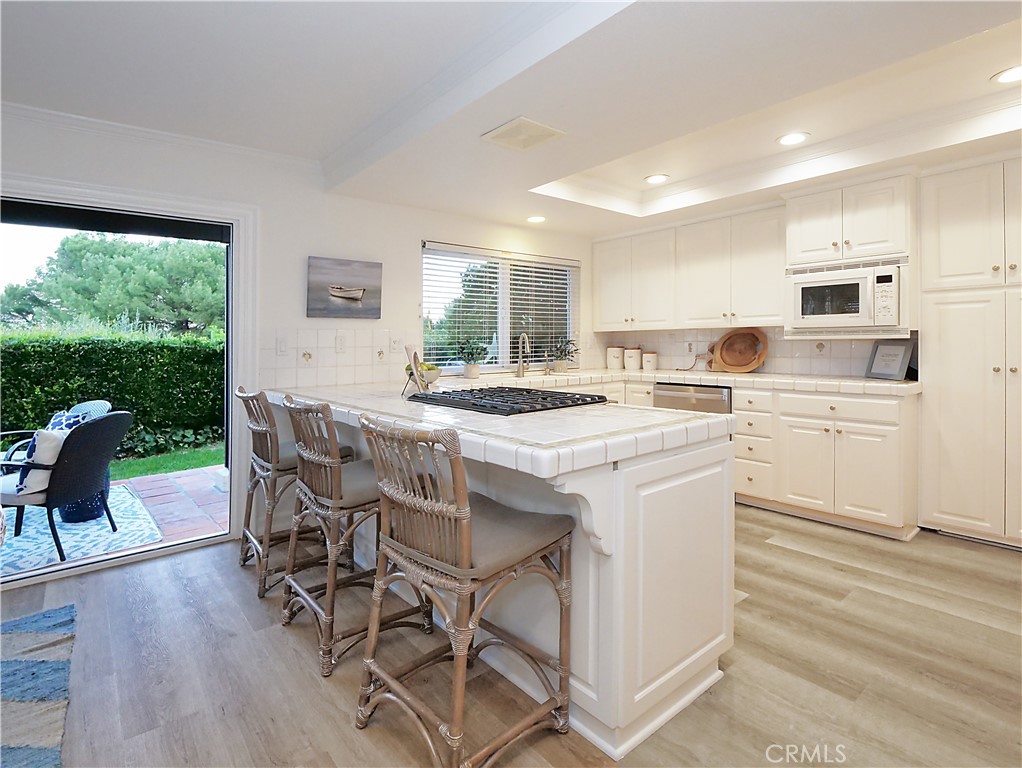 41 Oaktree Lane Rolling Hills Estates, CA 90274 - Photo 8 of 35 a kitchen with a table chairs stove and cabinets