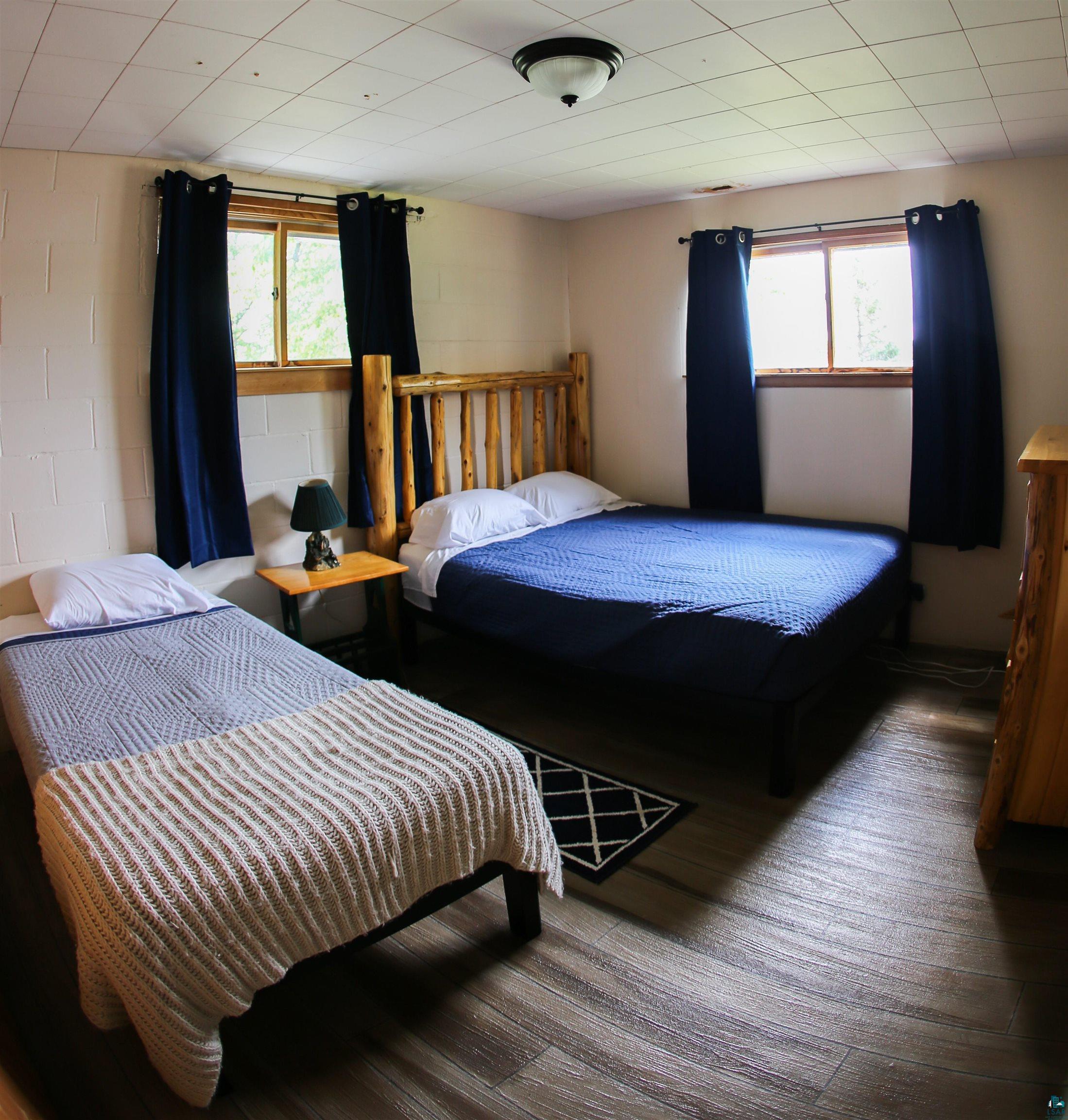 444 Fernberg Road, Unit 11 Ely, MN 55731 - Photo 6 of 19 Bedroom with multiple windows and wood finished floors