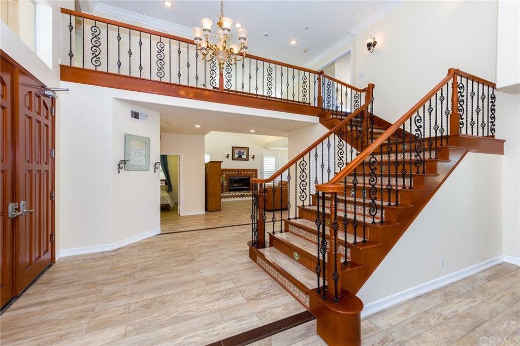 3834 Sky View Lane La Crescenta, CA 91214 - Photo 20 of 38 a view of staircase with lots of frames on wall and wooden floor