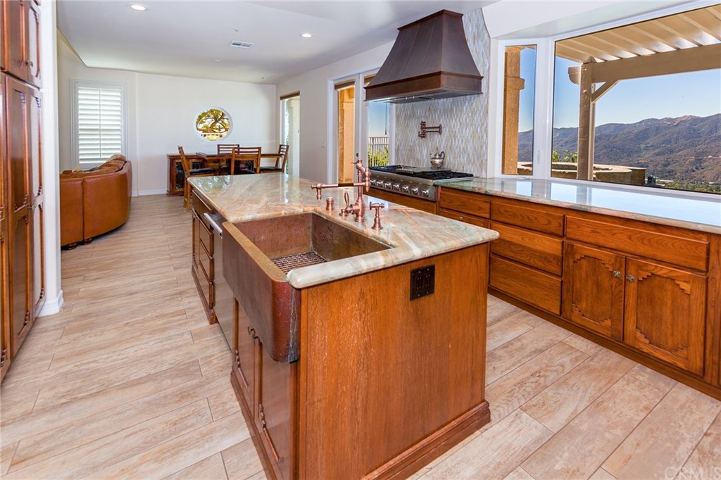 3834 Sky View Lane La Crescenta, CA 91214 - Photo 10 of 38 a kitchen with stainless steel appliances granite countertop a sink a stove and a wooden floors