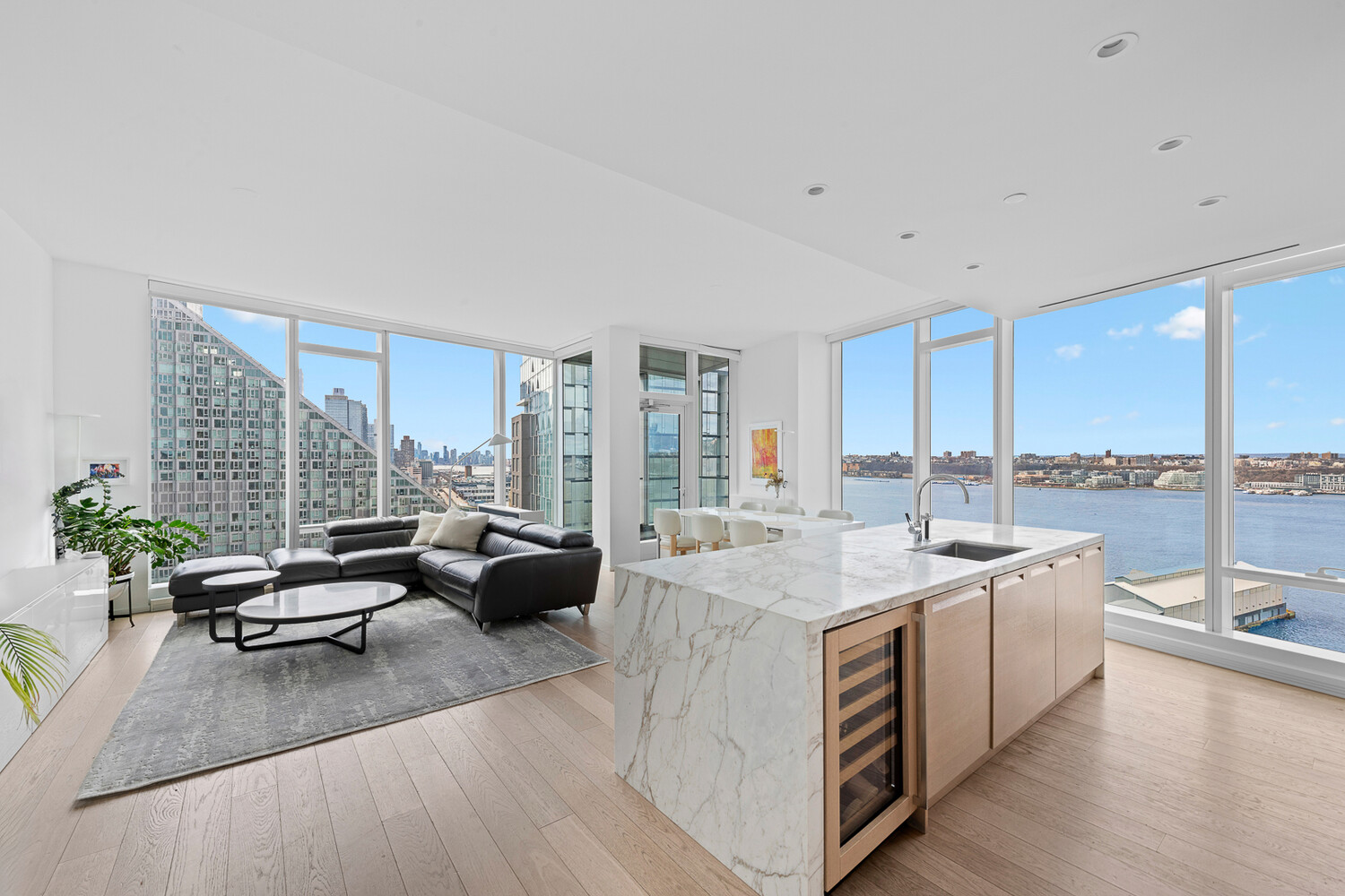 30 Riverside Boulevard, Unit 21M Manhattan, NY 10069 - Photo 1 of 38 a living room with furniture and floor to ceiling windows