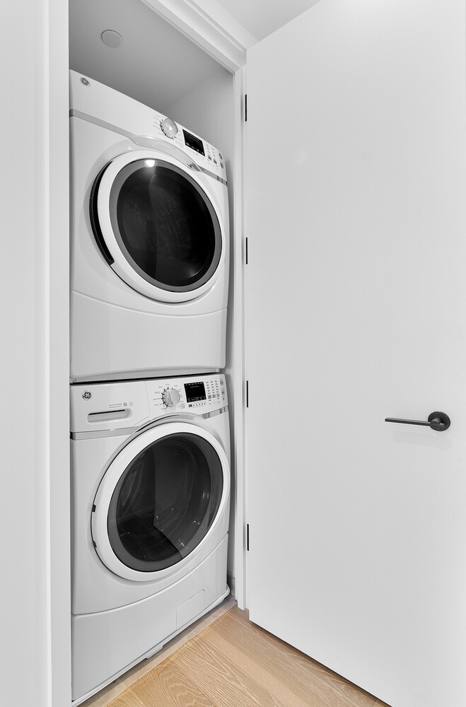 30 Riverside Boulevard, Unit 21M Manhattan, NY 10069 - Photo 11 of 38 a utility room with dryer and washer