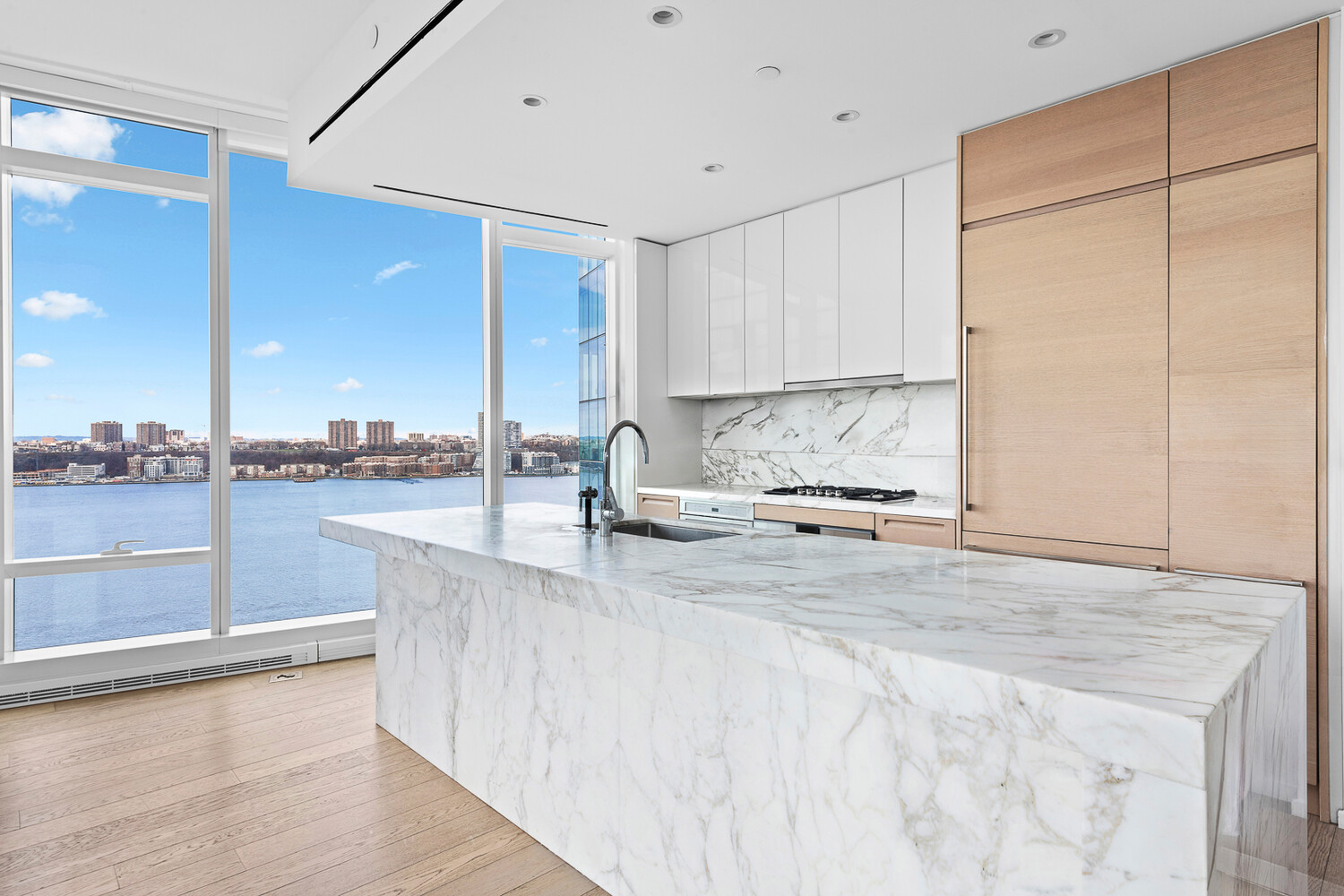 30 Riverside Boulevard, Unit 21M Manhattan, NY 10069 - Photo 4 of 38 a kitchen with stainless steel appliances granite countertop a sink a stove and a white cabinets