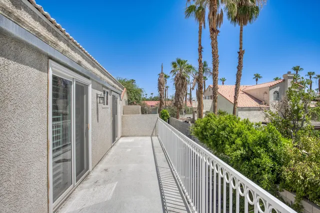 a view of a house with palm trees
