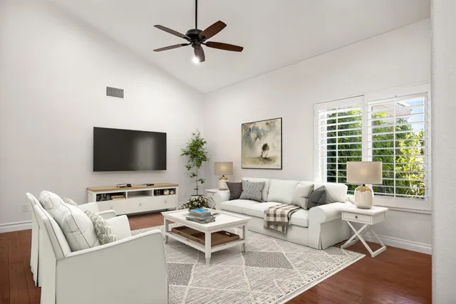 a living room with furniture a rug and a flat screen tv
