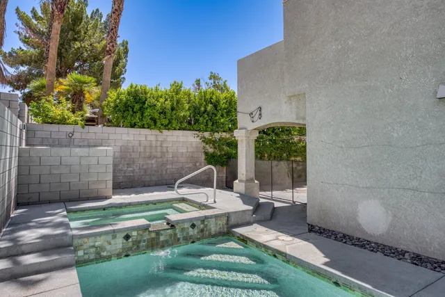 a view of a chair and table in backyard