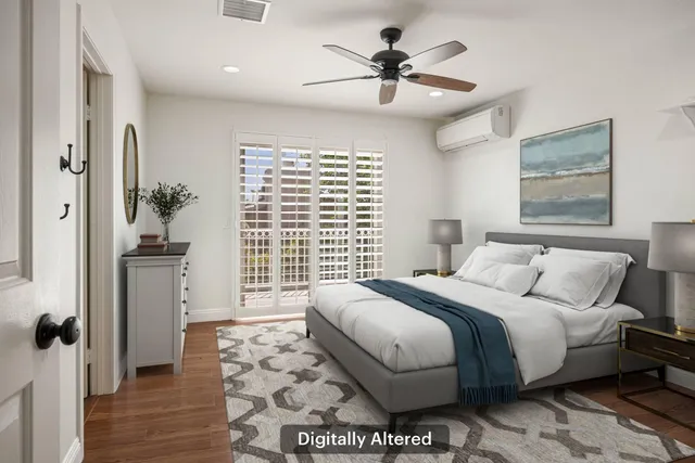 a bedroom with a large bed and a chandelier