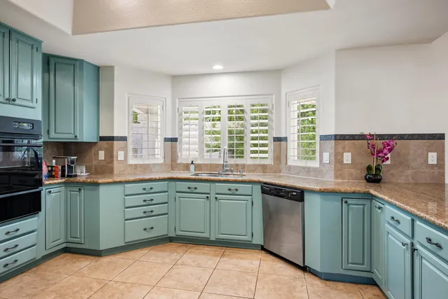 a kitchen with stainless steel appliances granite countertop a sink and cabinets